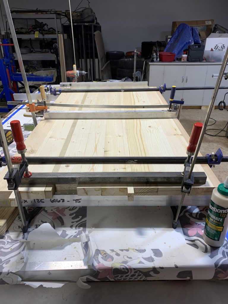 The wood with various clamps on across the top to glue to pieces together