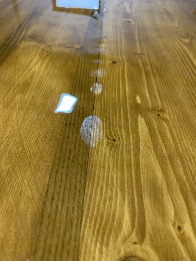 A close up where resin sank between two pieces of wood that weren't sealed together.