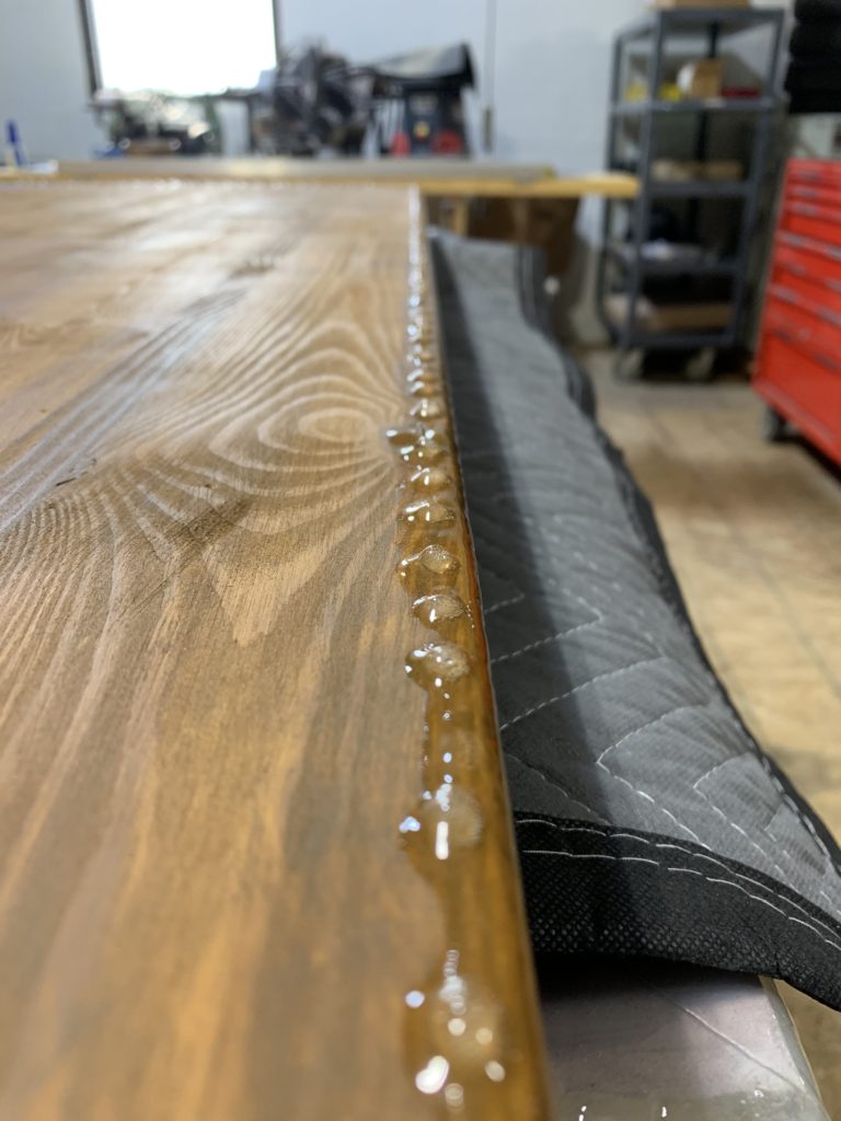 The bottom of the desk showing how the resin set dripping over the edge.